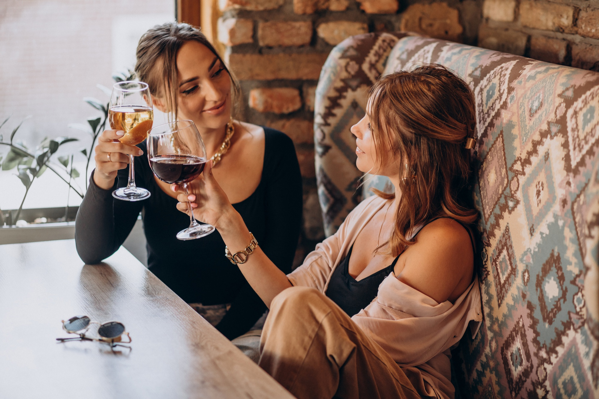 two-attractive-girls-sitting-cafe-drinking-wine