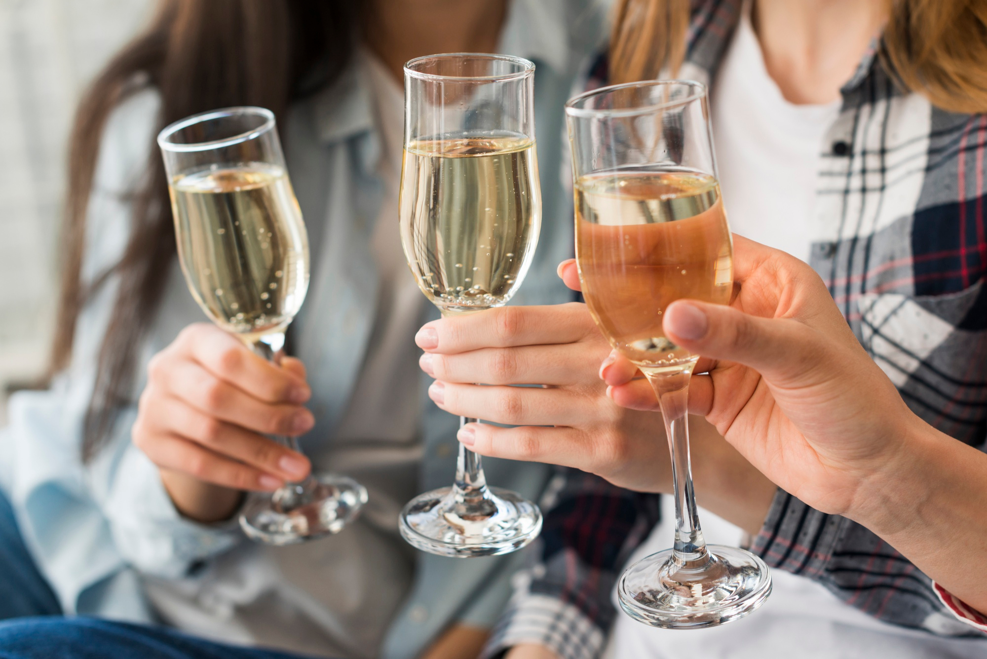 women-holding-champagne-glasses-toast